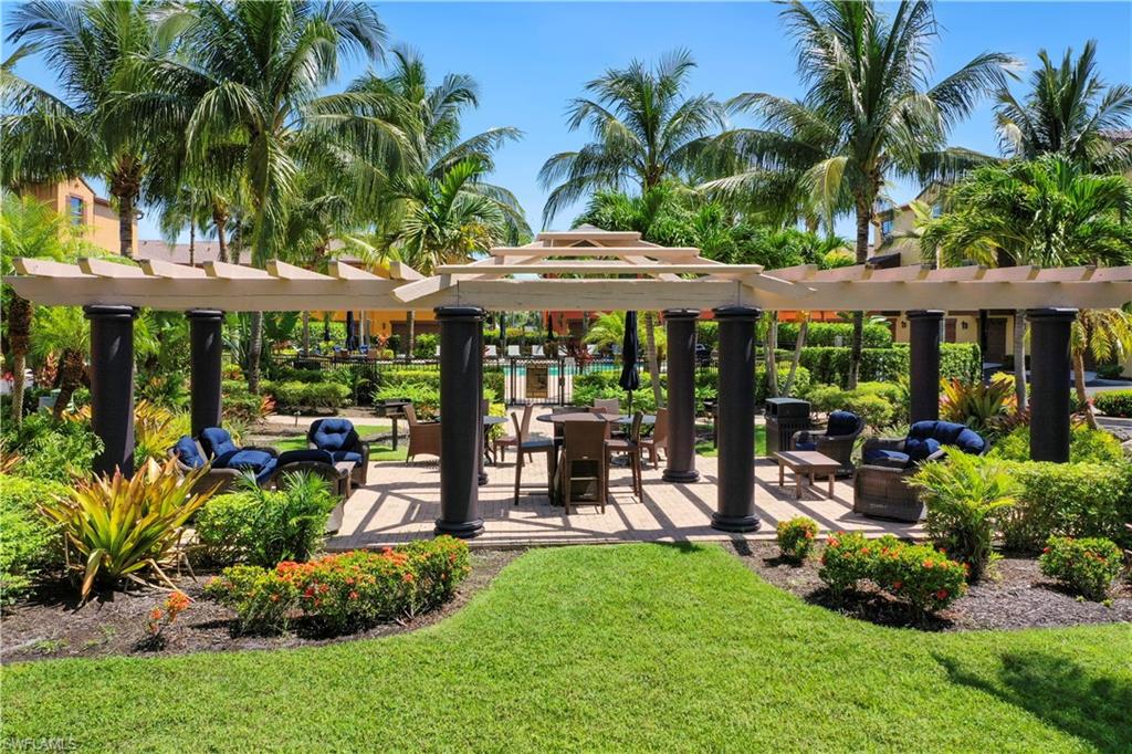 9063 Capistrano Street North, Unit 4405 Naples, FL 34113 - Photo 16 of 40 a view of a house with backyard and porch