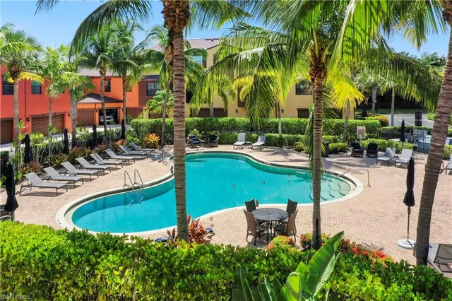 a view of a swimming pool with a table and chairs