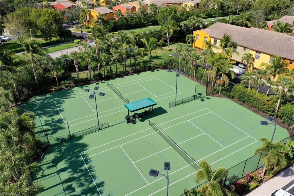 9063 Capistrano Street North, Unit 4405 Naples, FL 34113 - Photo 24 of 40 an aerial view of a tennis ground and tennis court