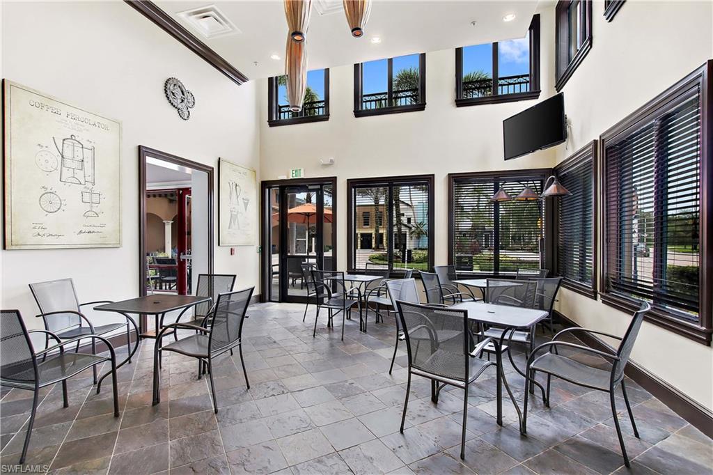 9063 Capistrano Street North, Unit 4405 Naples, FL 34113 - Photo 29 of 40 a view of a dining room with furniture