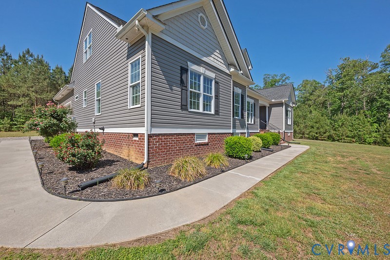 9425 Marie Road New Kent, VA 23124 - Photo 50 of 55 a view of a house with brick walls plants and large tree
