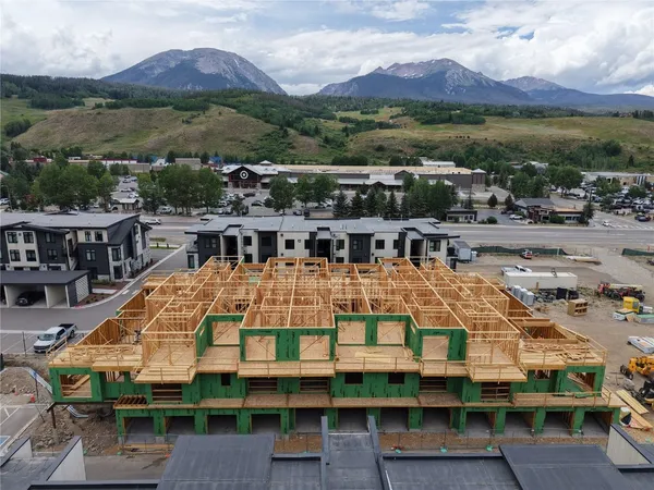 a aerial view of a house with a mountain