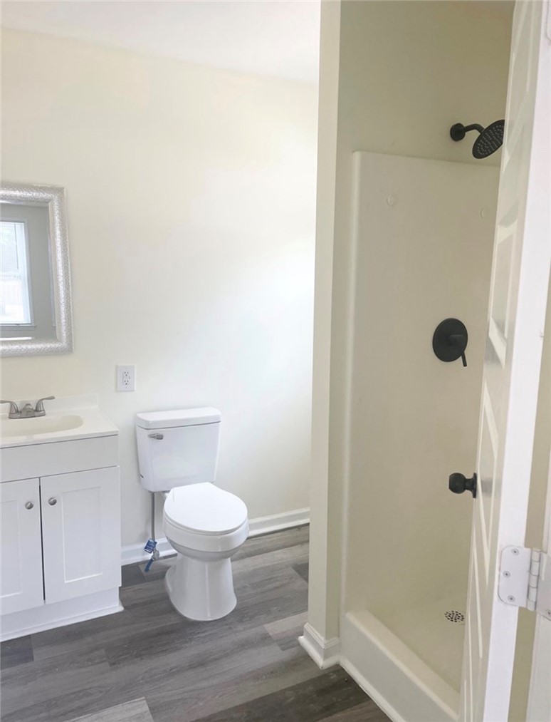 208 Hampton Street Iva, SC 29655 - Photo 10 of 19 This sleek bathroom features a modern vanity, a spacious shower, and elegant flooring.