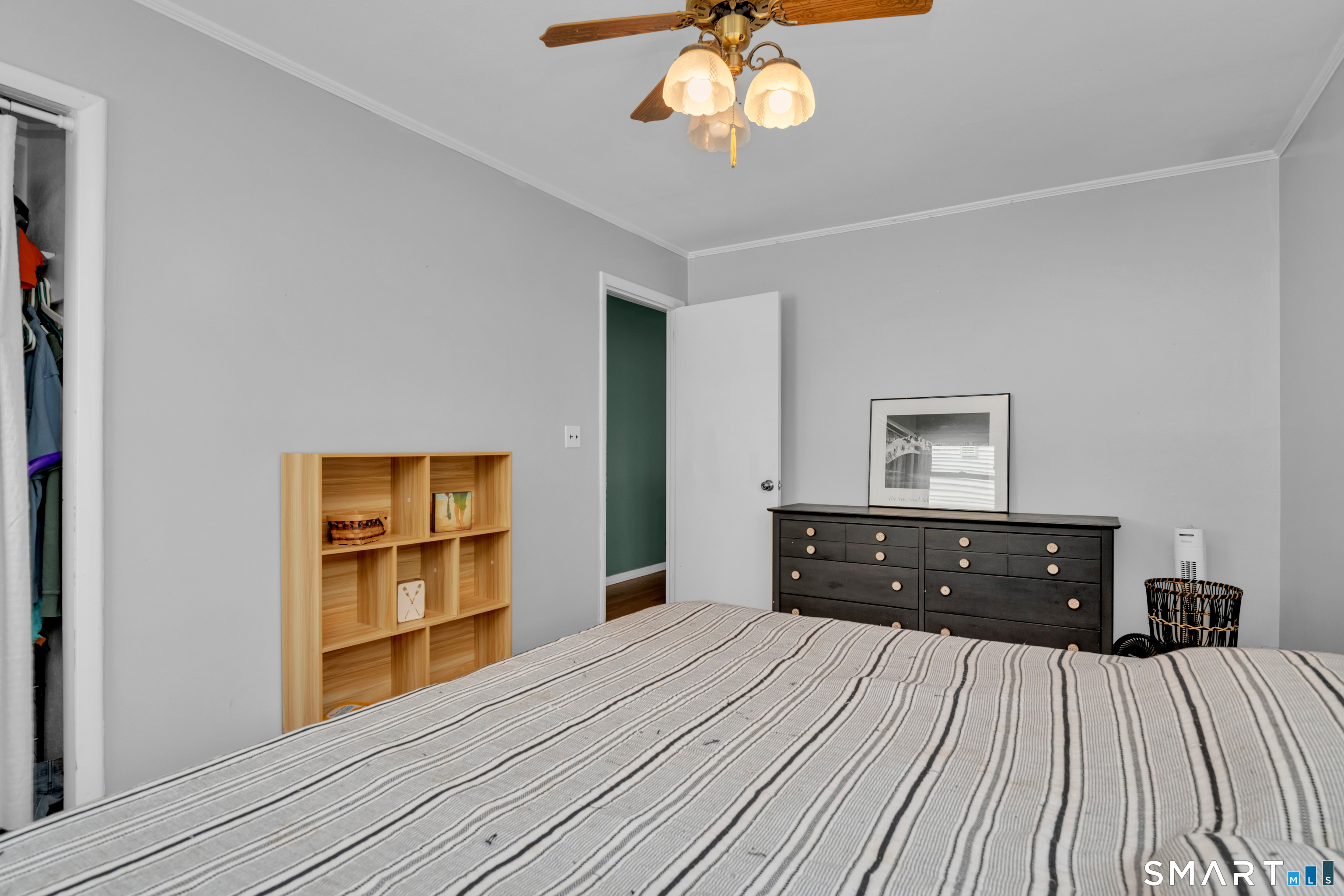 81 Crystal Street Wethersfield, CT 06109 - Photo 30 of 40 a bedroom with a bed and a chandelier
