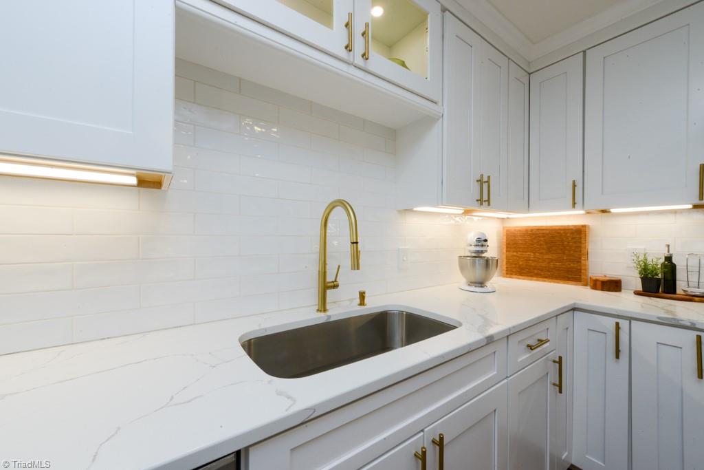 1410 Heathcliff Road High Point, NC 27262 - Photo 22 of 50 subway tile backsplash and lighted cabinets