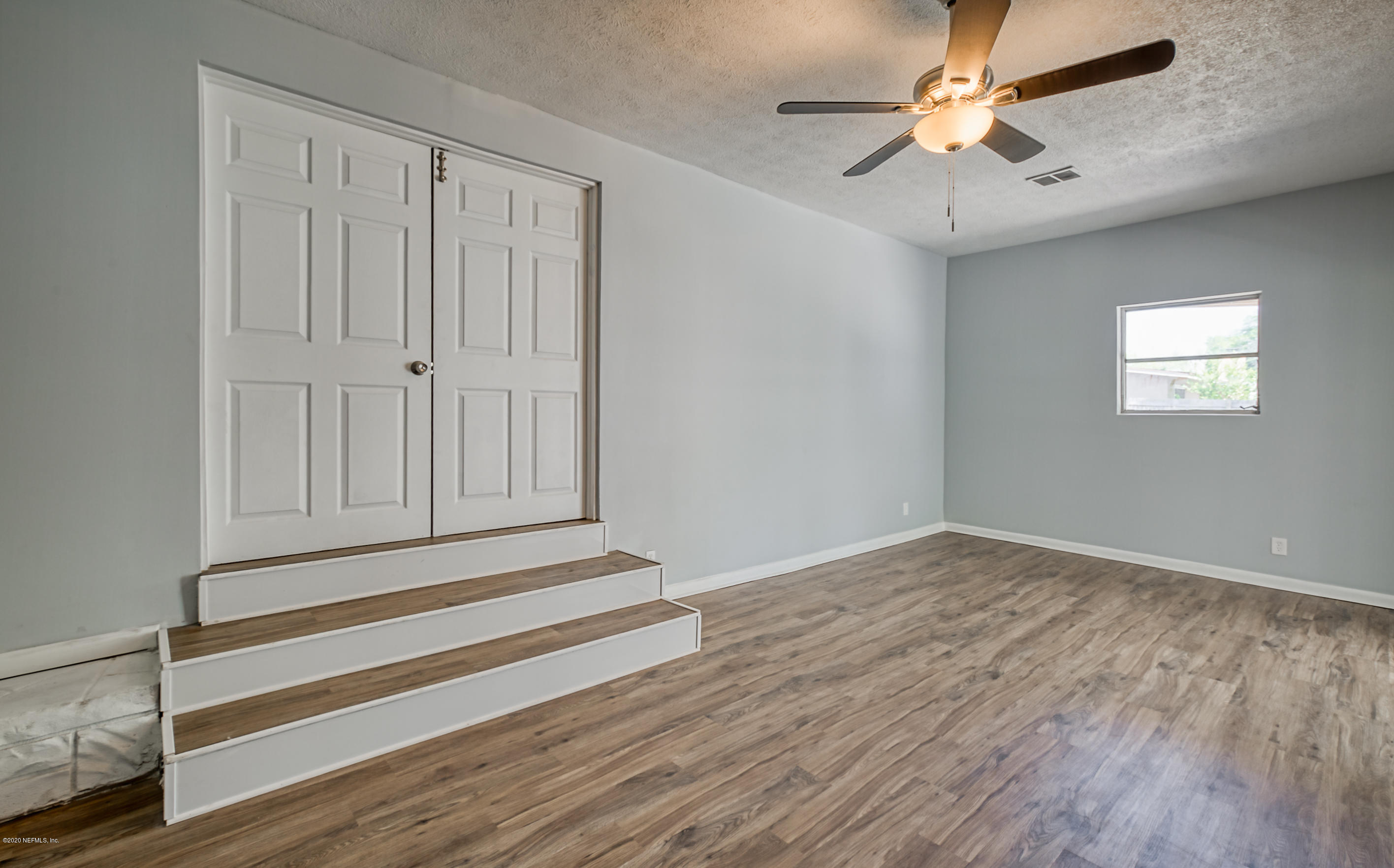 471 Sigsbee Road Orange Park, FL 32073 - Photo 11 of 17 wooden floor in an empty room with a window