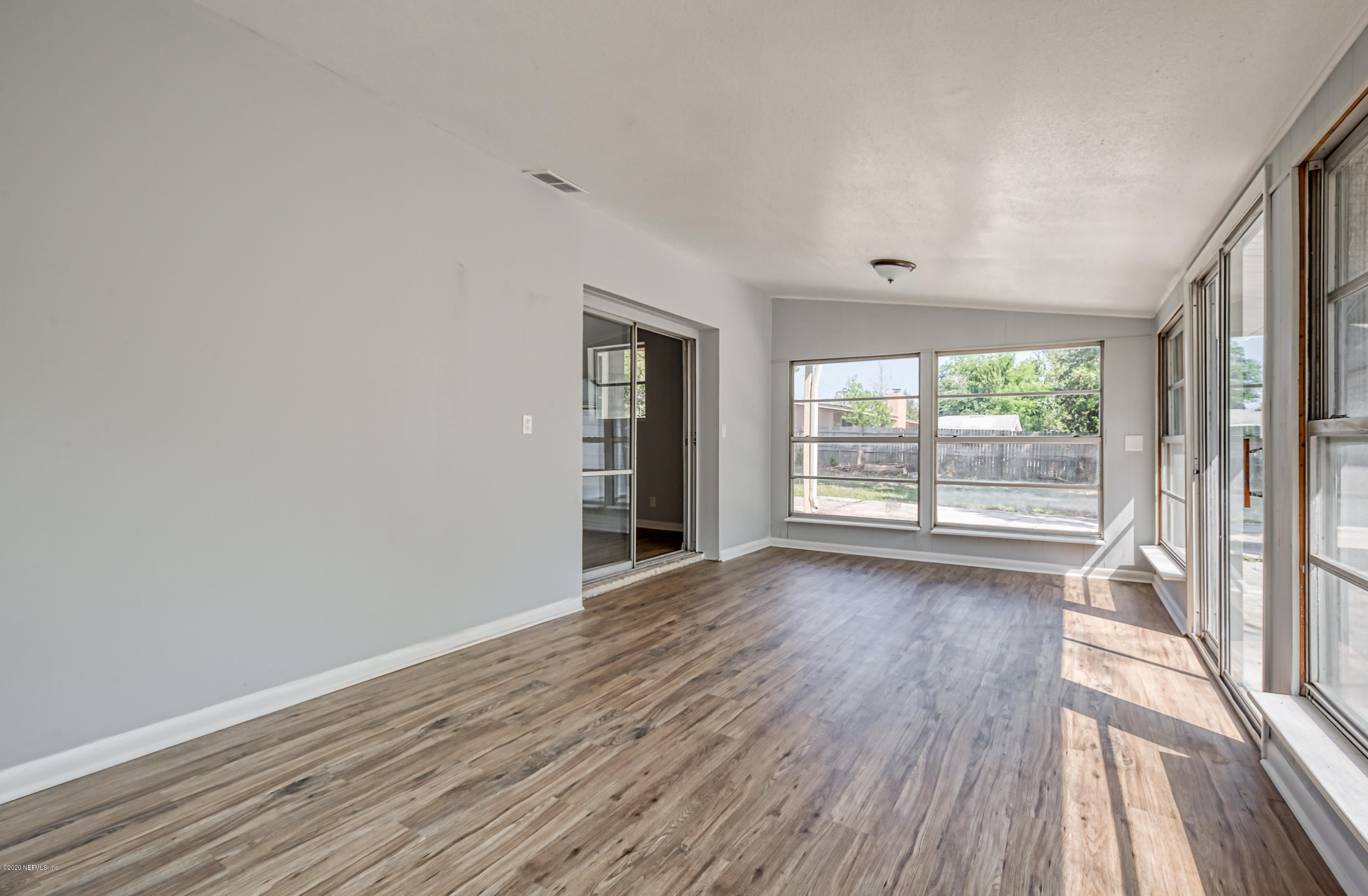 471 Sigsbee Road Orange Park, FL 32073 - Photo 3 of 17 wooden floor in an empty room with a window