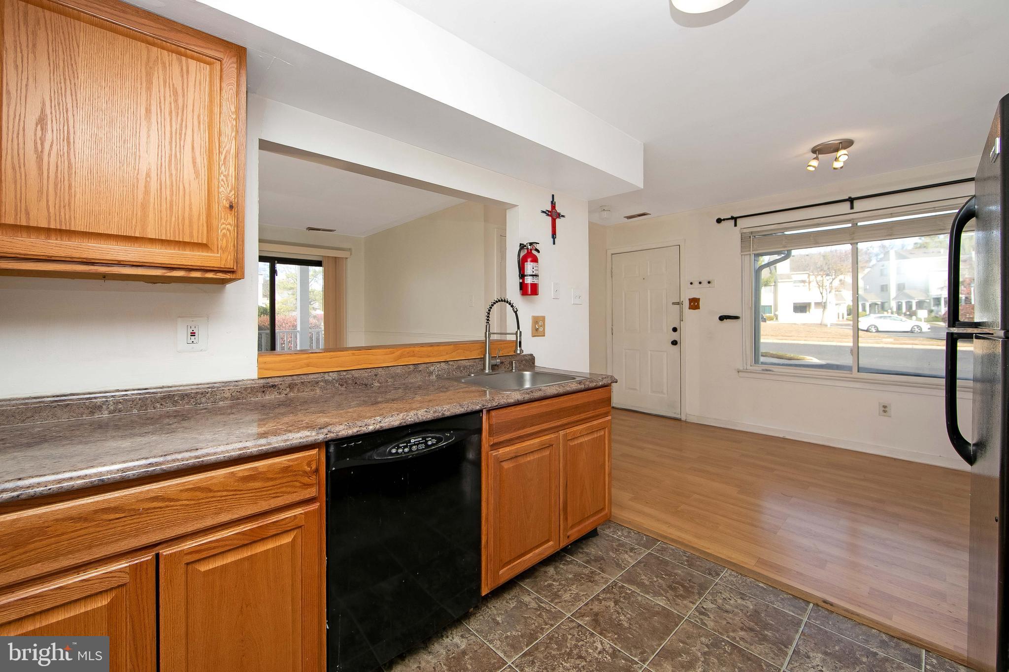 2207 Sandra Road Voorhees, NJ 08043 - Photo 11 of 24 a kitchen with granite countertop a sink cabinets and a wooden floor