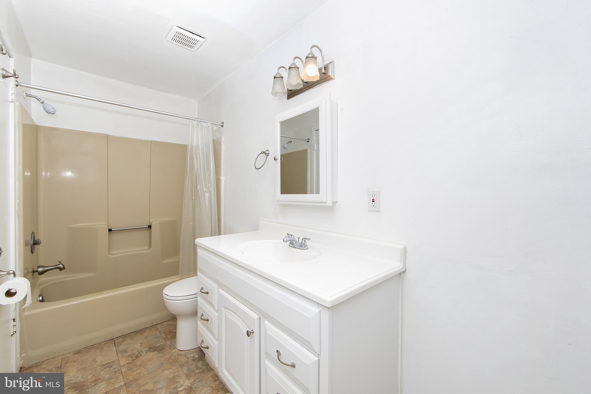 2207 Sandra Road Voorhees, NJ 08043 - Photo 16 of 24 a bathroom with a sink a toilet and shower