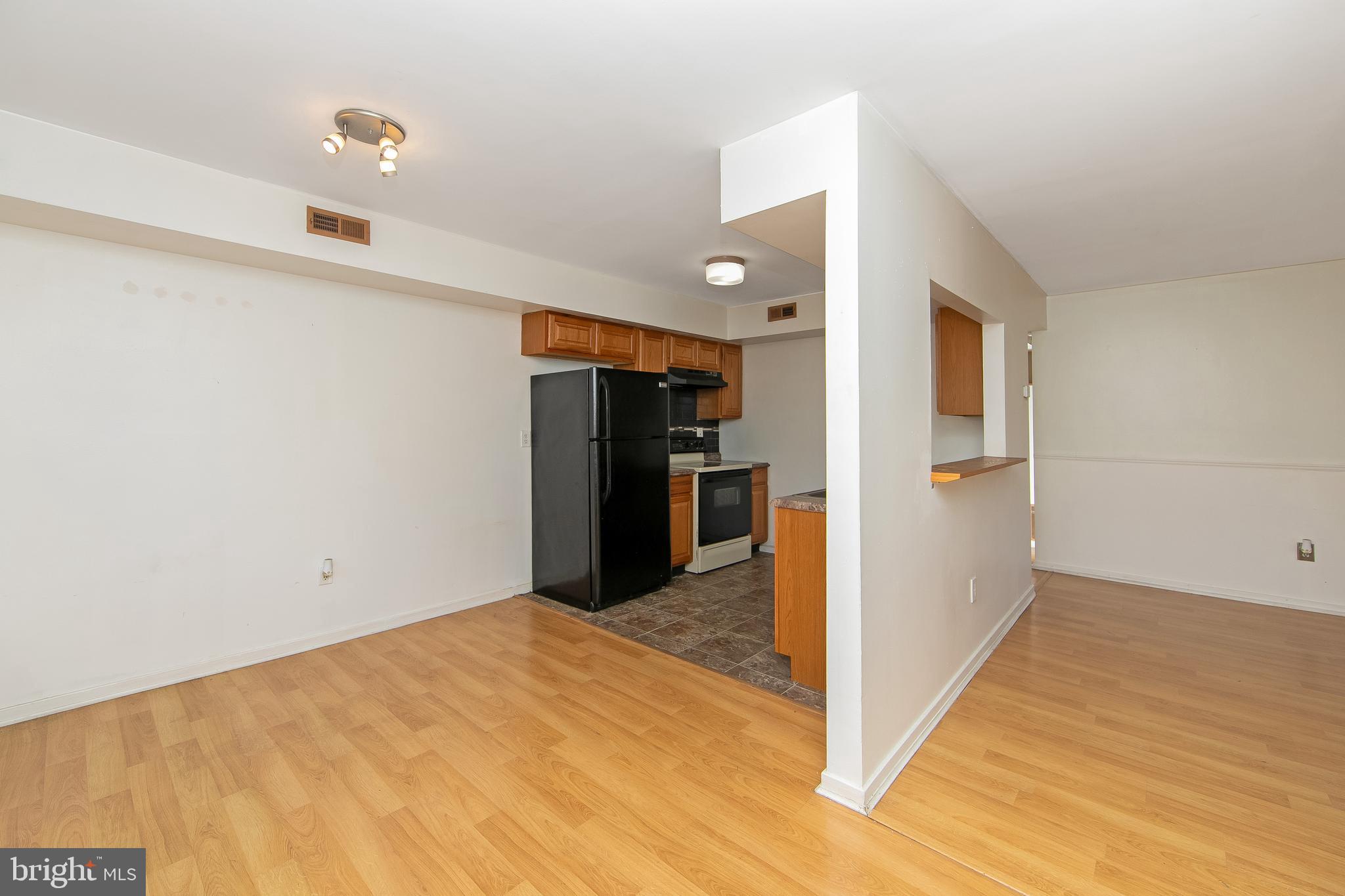 2207 Sandra Road Voorhees, NJ 08043 - Photo 5 of 24 a view of a kitchen with wooden floor and a refrigerator