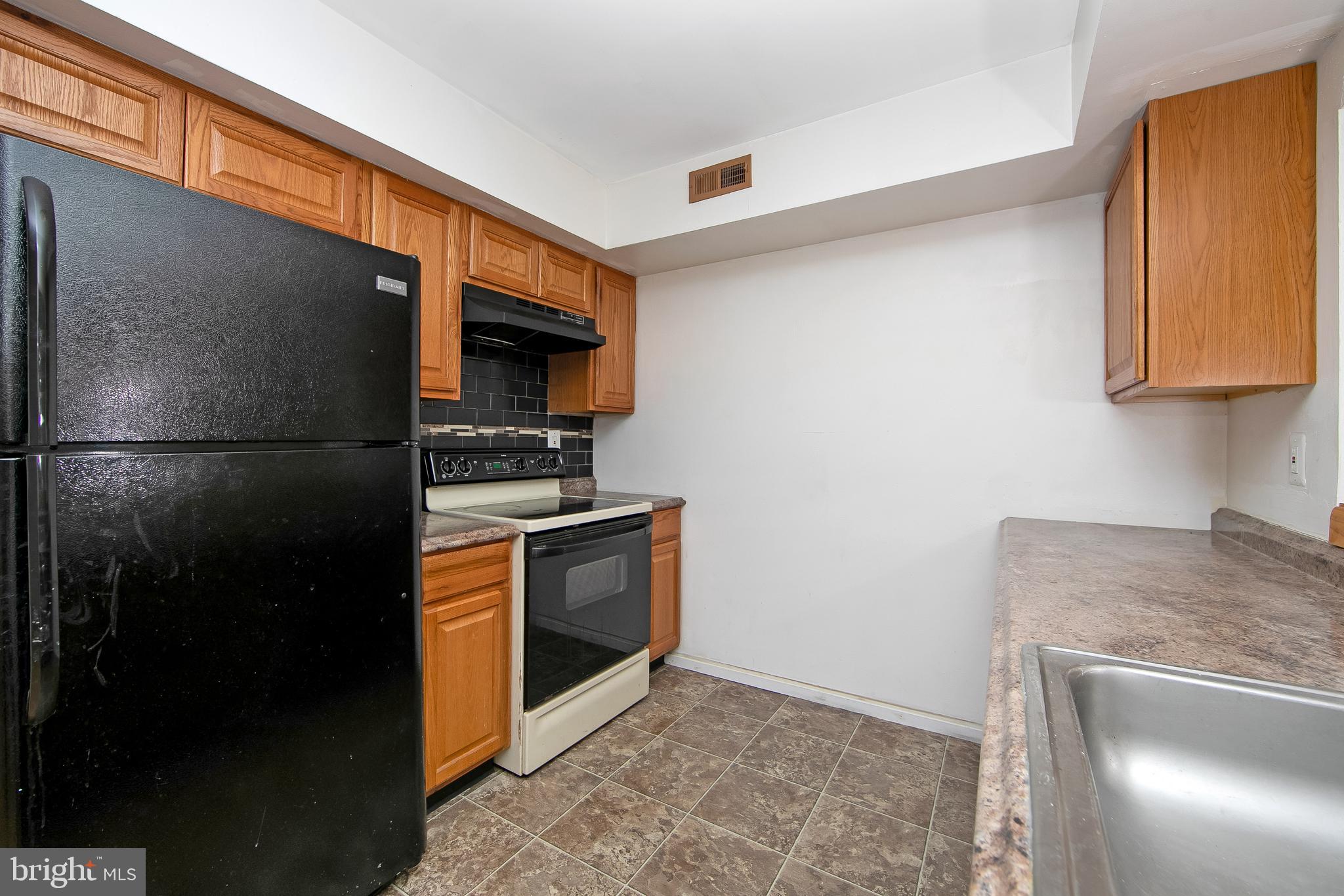 2207 Sandra Road Voorhees, NJ 08043 - Photo 10 of 24 a kitchen with a refrigerator and a stove