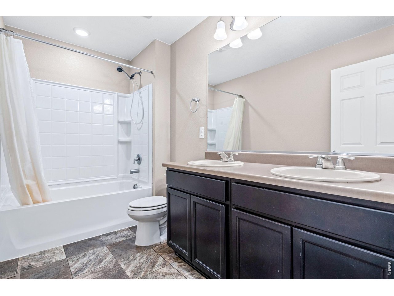 415 3rd Street Severance, CO 80550 - Photo 12 of 21 a bathroom with a double vanity sink toilet and shower