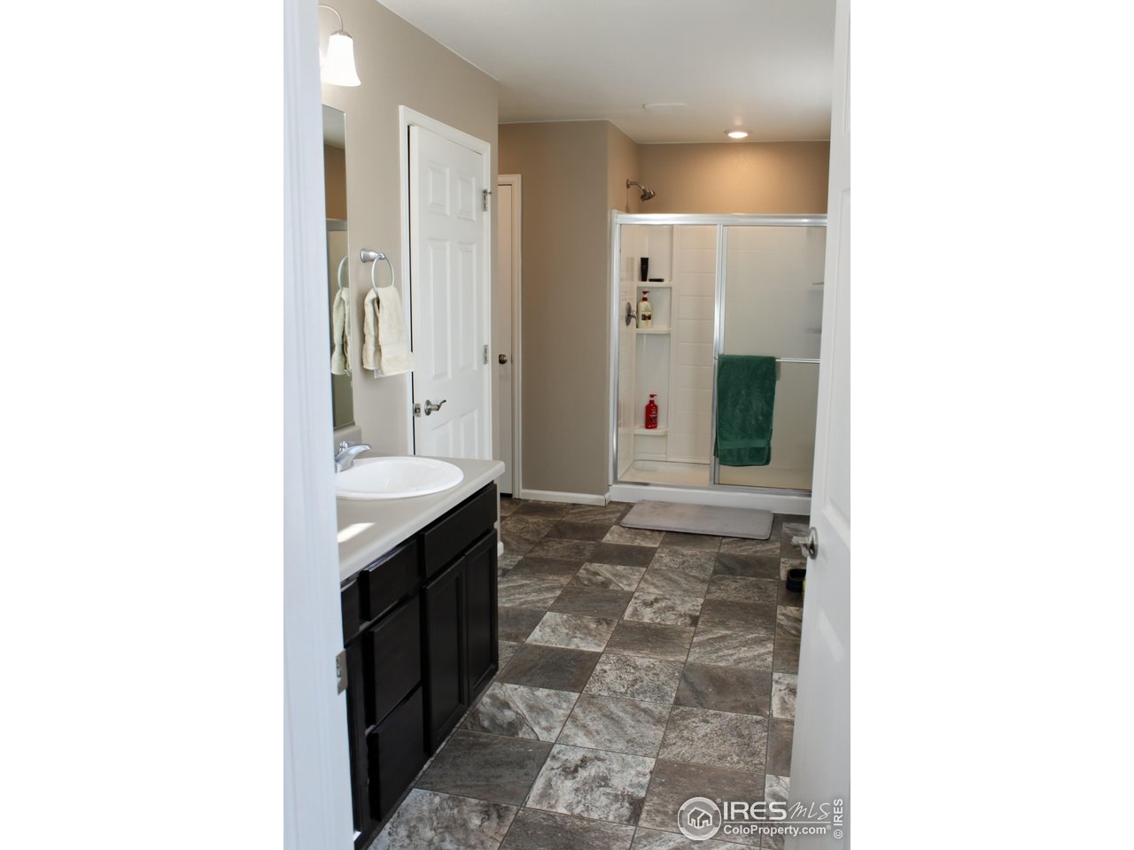 415 3rd Street Severance, CO 80550 - Photo 12 of 25 a bathroom with a sink and a mirror