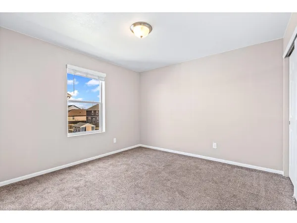 a view of an empty room and closet area