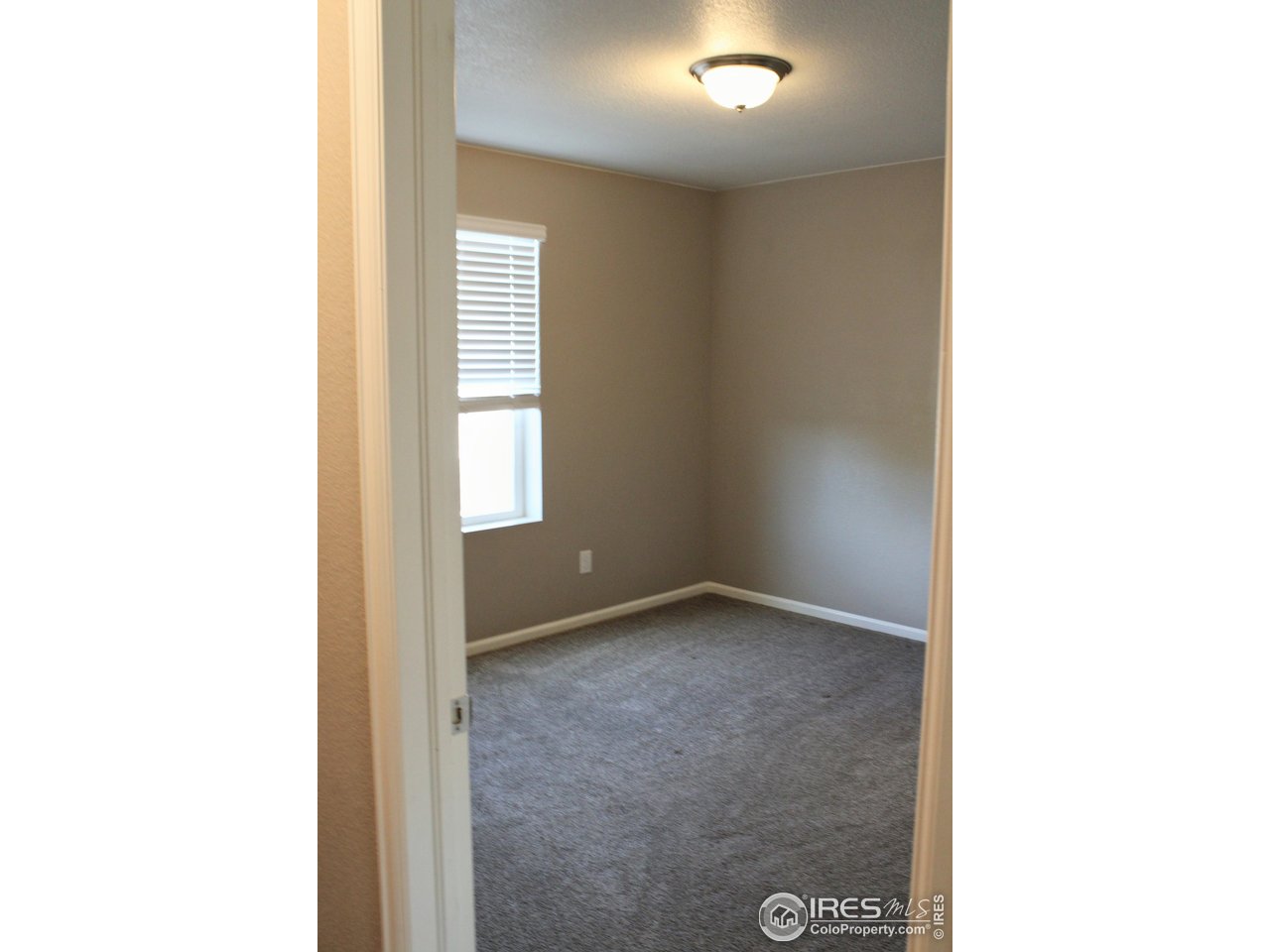 415 3rd Street Severance, CO 80550 - Photo 15 of 25 a view of an empty room with a window