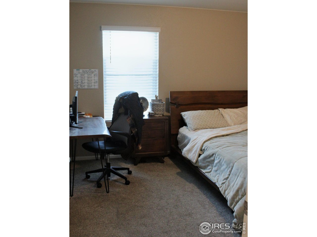 415 3rd Street Severance, CO 80550 - Photo 19 of 25 a bedroom with a bed and a chair