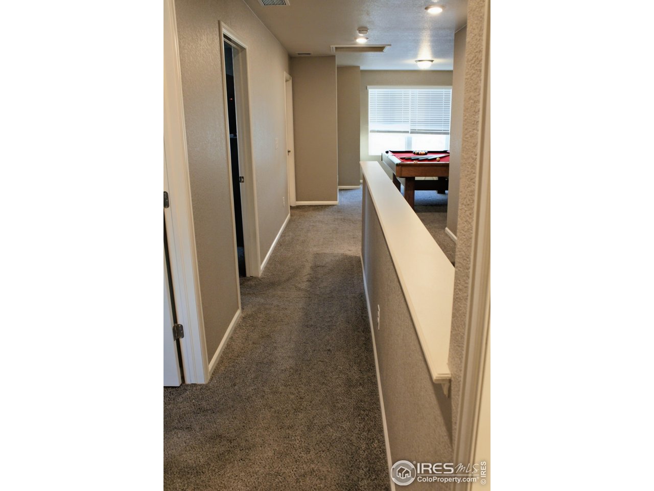 415 3rd Street Severance, CO 80550 - Photo 21 of 25 a view of a hallway with wooden floor and staircase