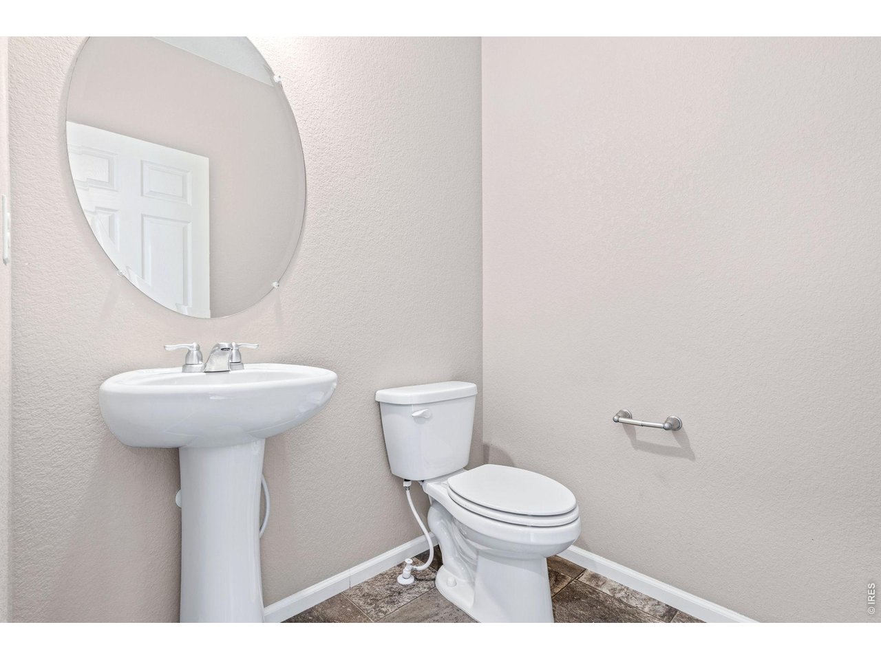 415 3rd Street Severance, CO 80550 - Photo 5 of 21 a bathroom with a toilet a sink and mirror