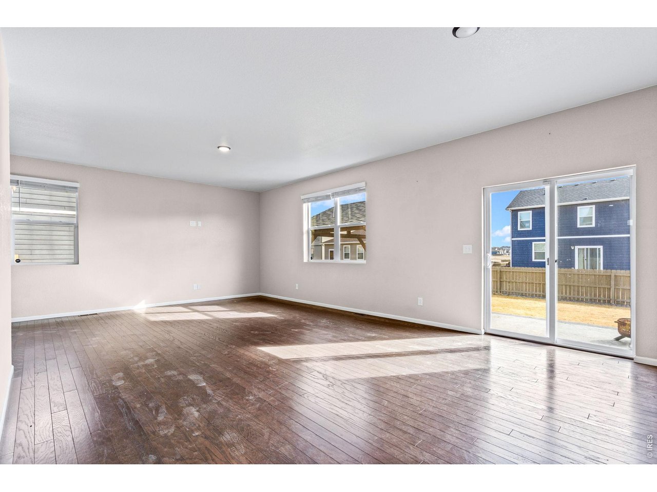 415 3rd Street Severance, CO 80550 - Photo 10 of 21 a view of an empty room with wooden floor and a window