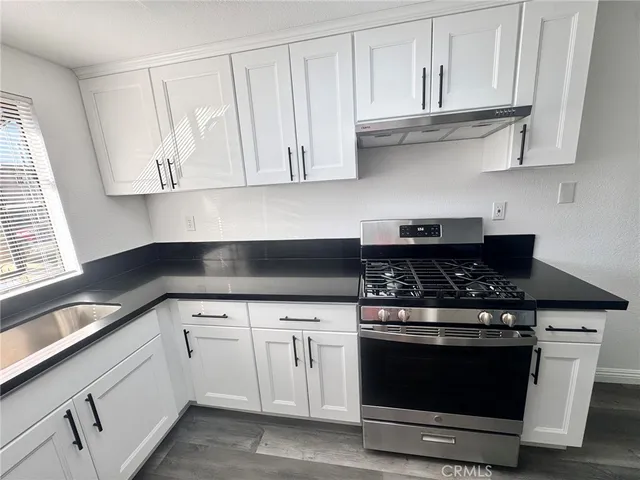 a white stove top oven sitting inside of a kitchen