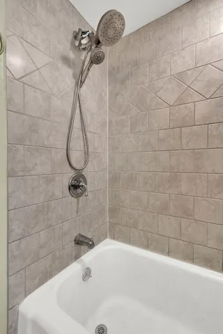 a bathroom with a bath tub with a shower