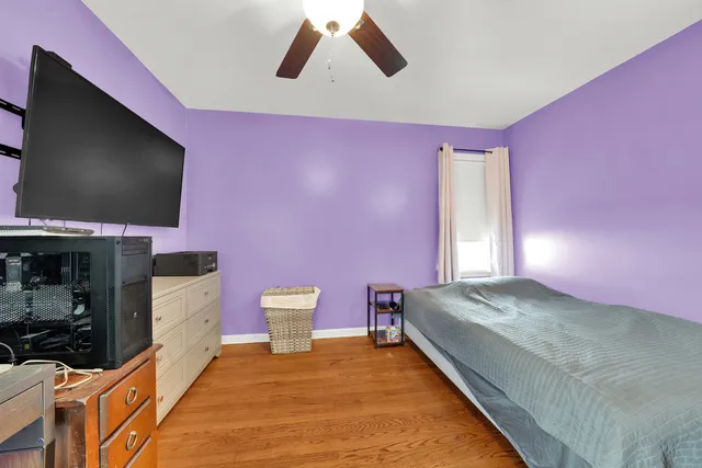 a spacious bedroom with a bed and a flat screen tv