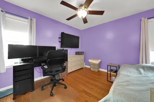 a view of a workspace with furniture and a window