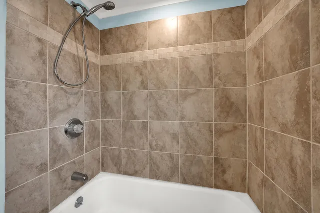 a bathroom with a shower and a shower head