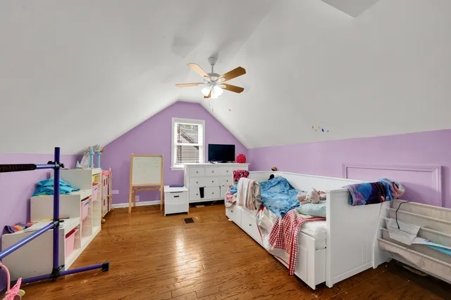 a bedroom with furniture and a wooden floor