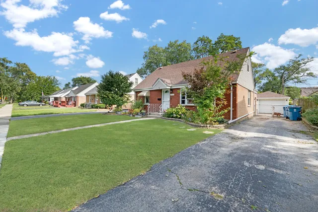 a view of a house with a big yard and large trees