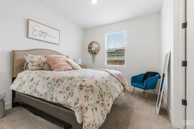 a bedroom with a bed and a chair