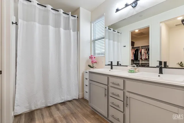 a bathroom with a double vanity sink and mirror