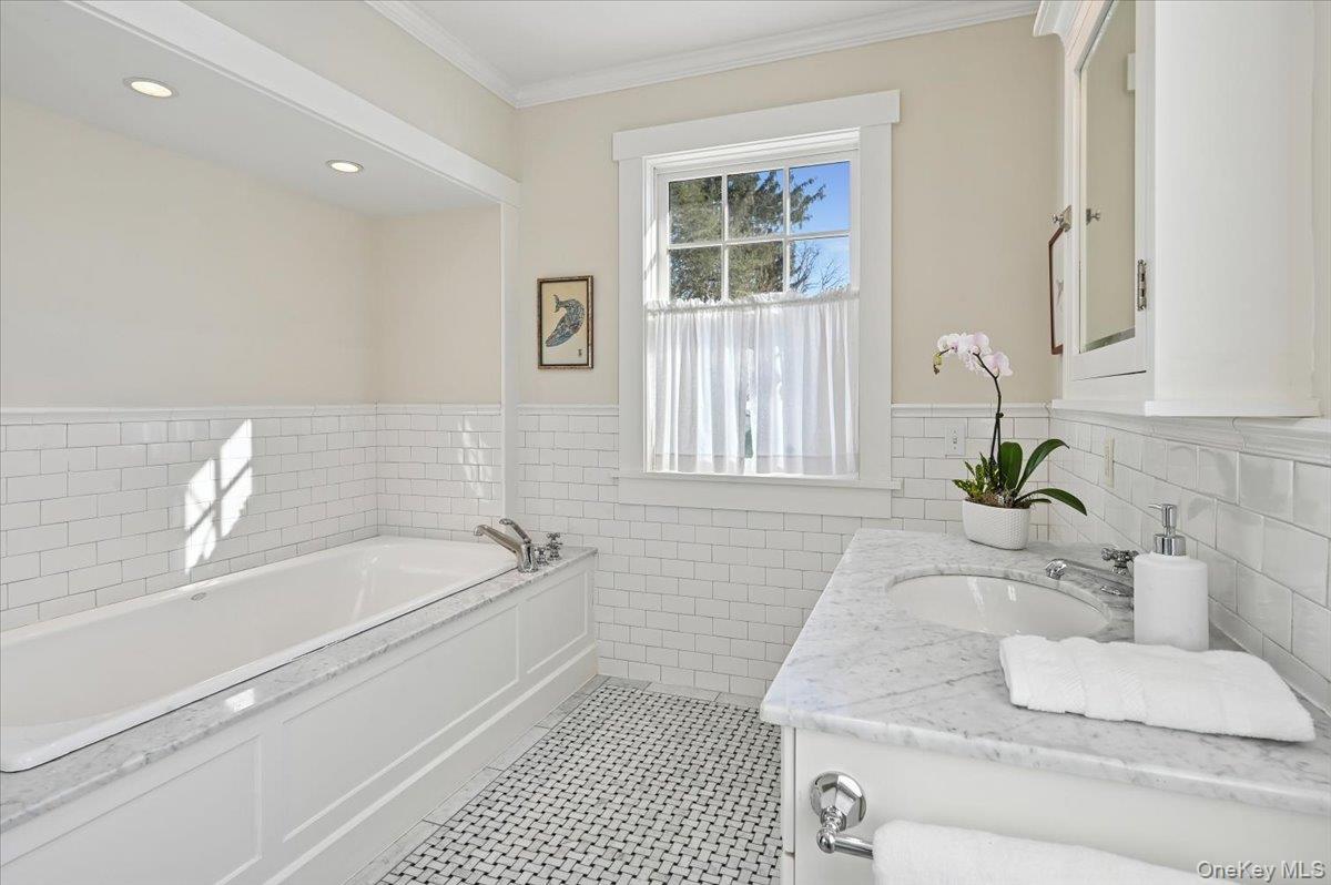 31 Emerson Road Larchmont, NY 10538 - Photo 20 of 39 The primary bath has a jacuzzi tub, and a built-in vanity.