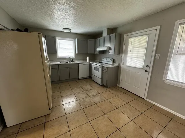 a kitchen with stainless steel appliances cabinets a sink and a stove