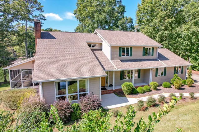 a aerial view of a house with a yard and potted plants