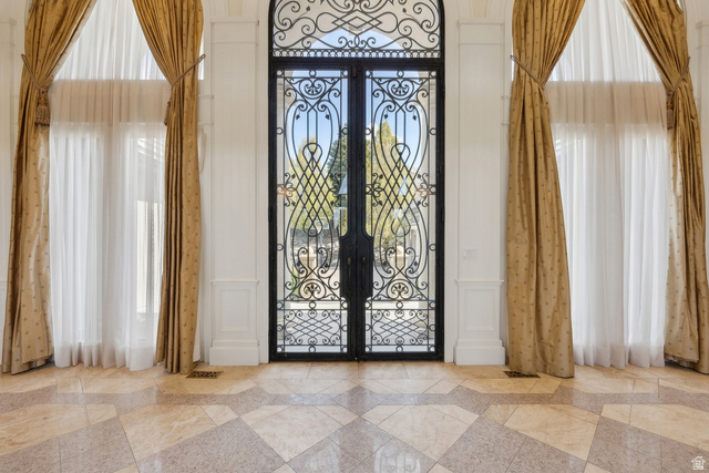 1714 Ridge Point Drive Bountiful, UT 84010 - Photo 15 of 132 Ornate wrought iron double entry doors, flanking tall windows with arched transoms, and a patterned tile floor