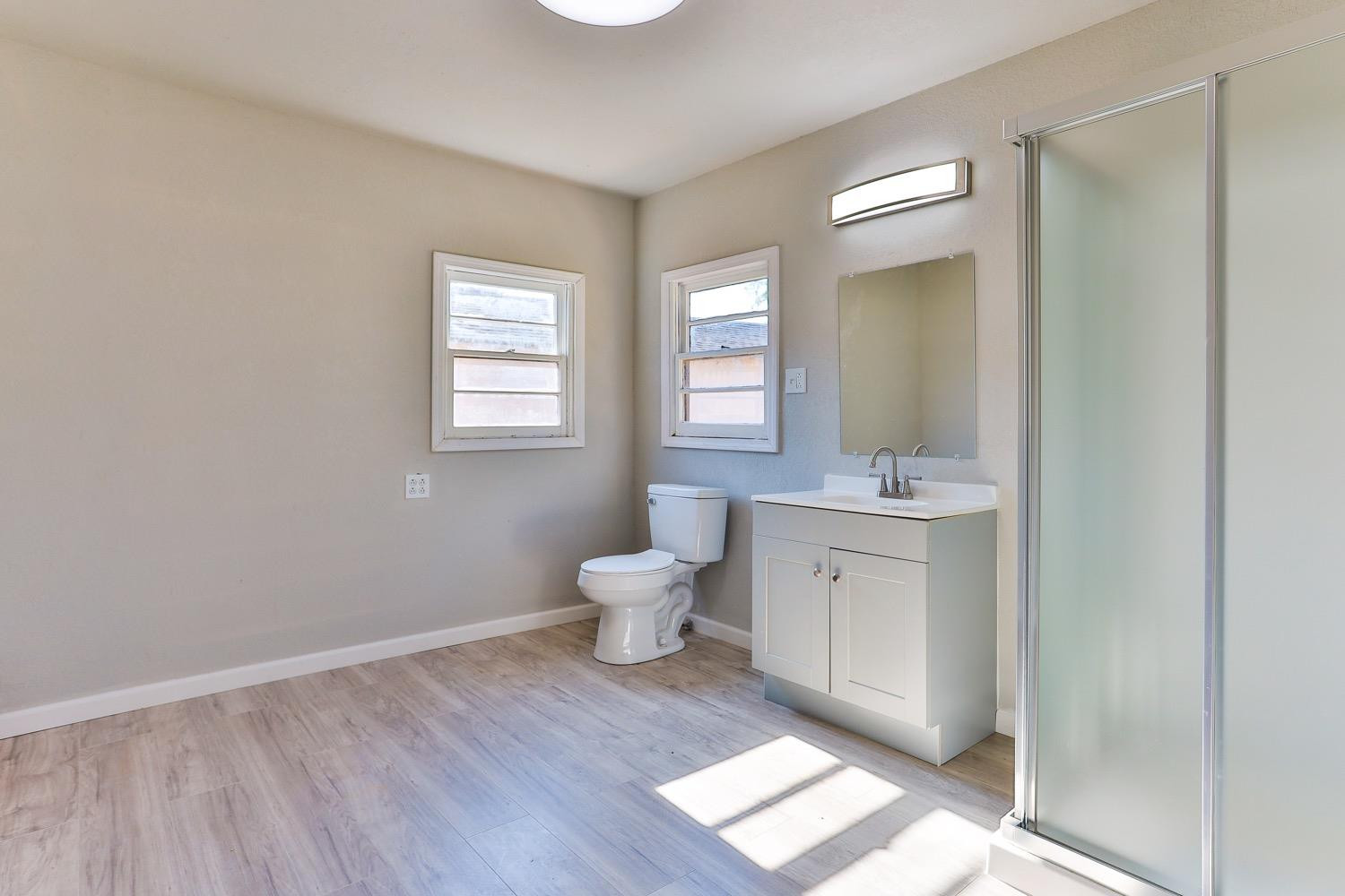 435 West Lynn Street Slaton, TX 79364 - Photo 12 of 22 a bathroom with a toilet sink and mirror
