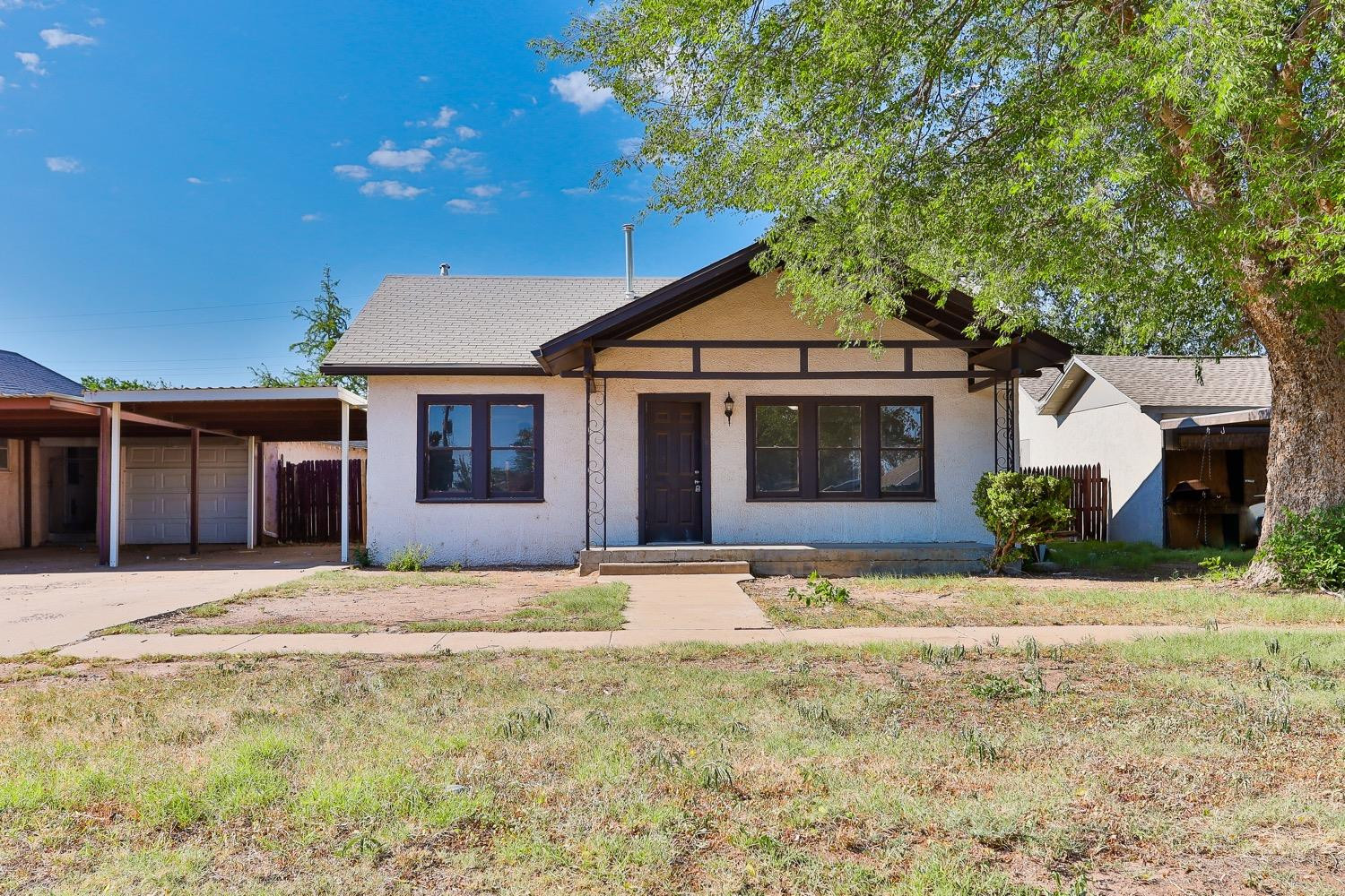 435 West Lynn Street Slaton, TX 79364 - Photo 17 of 22 a front view of a house with a yard and garage