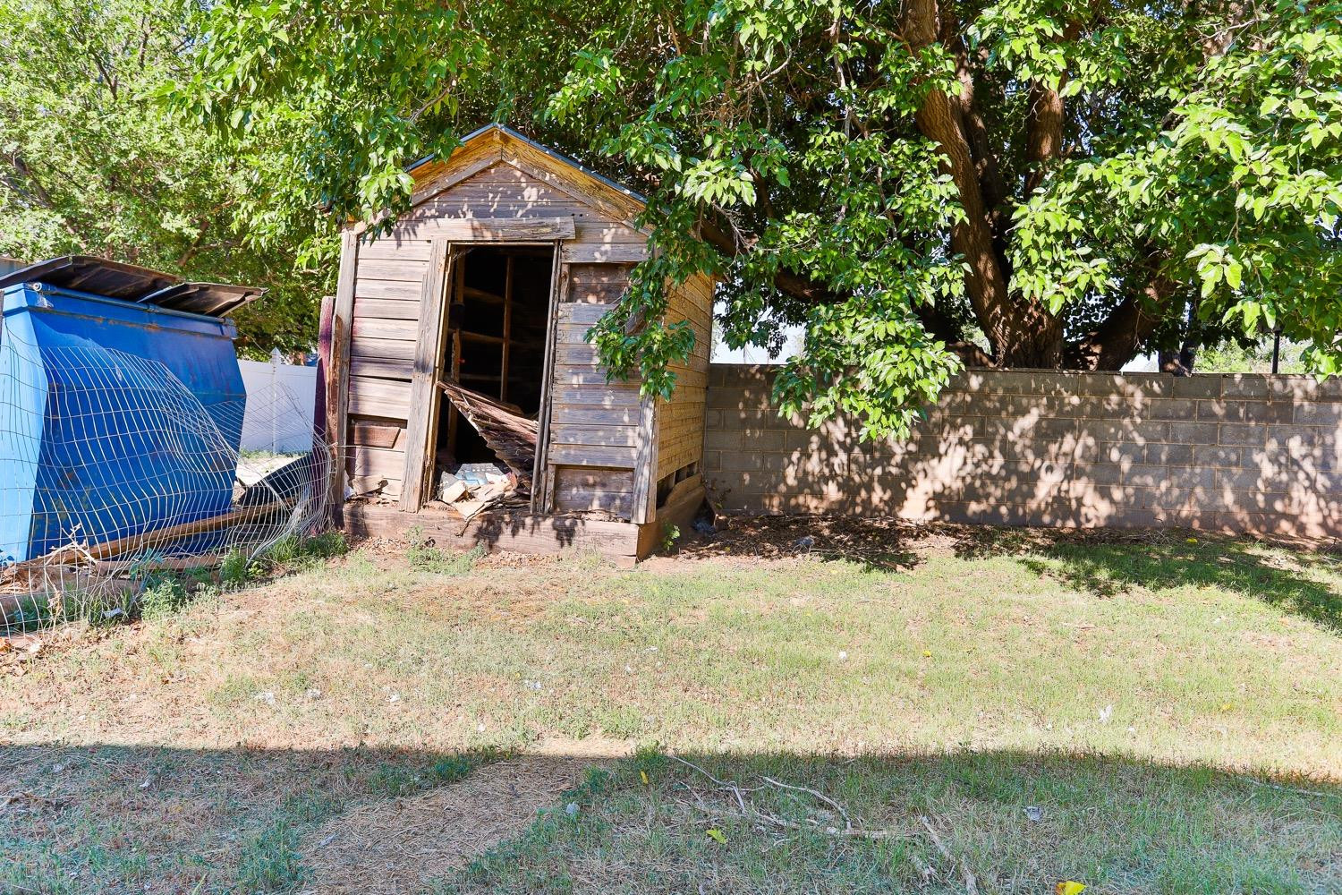 435 West Lynn Street Slaton, TX 79364 - Photo 22 of 22 a view of wooden house and a yard