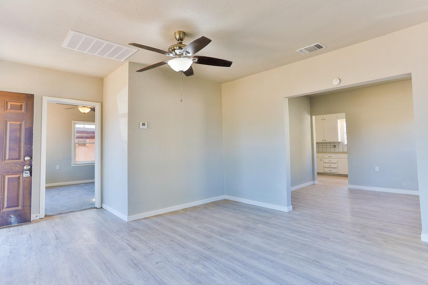 435 West Lynn Street Slaton, TX 79364 - Photo 4 of 22 a view of an empty room with wooden floor