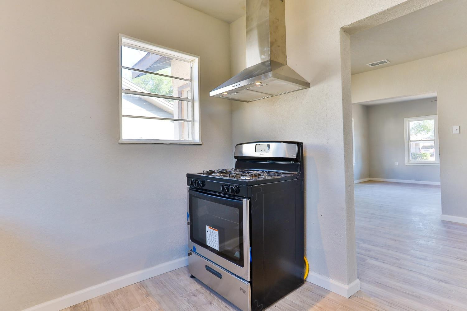 435 West Lynn Street Slaton, TX 79364 - Photo 7 of 22 a kitchen with a stove and a microwave