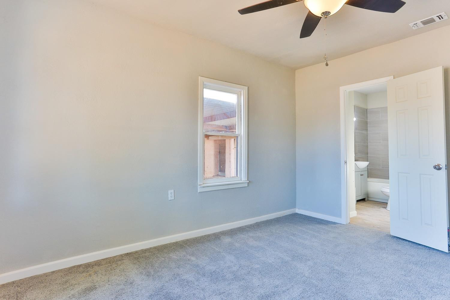 435 West Lynn Street Slaton, TX 79364 - Photo 8 of 22 a view of an empty room with a window