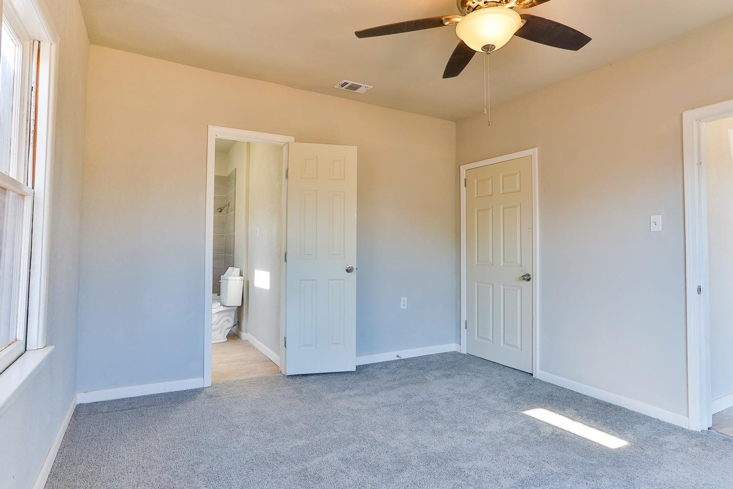 435 West Lynn Street Slaton, TX 79364 - Photo 9 of 22 a view of an empty room with a window
