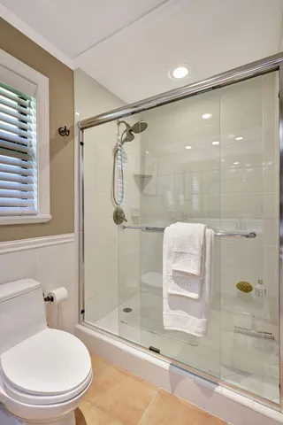 a bathroom with a shower and a toilet