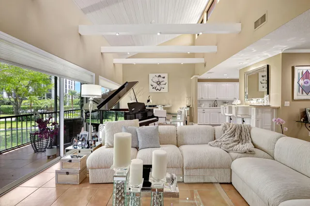 a dining room with wooden floor and a floor to ceiling window