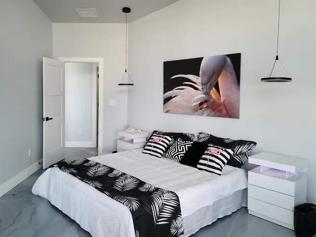 swimming pool view with couches lamp on table and chairs