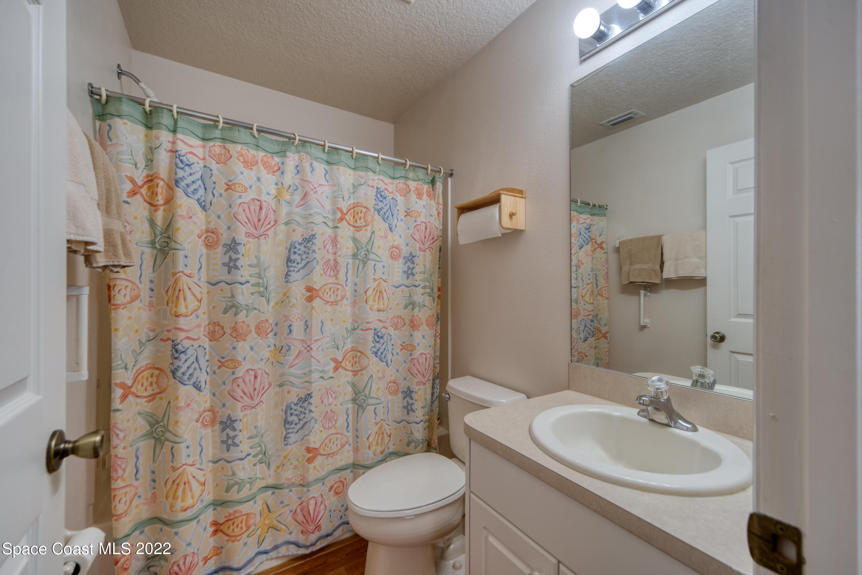 995 Luminary Circle, Unit 103 Melbourne, FL 32901 - Photo 20 of 27 a bathroom with a sink toilet and shower