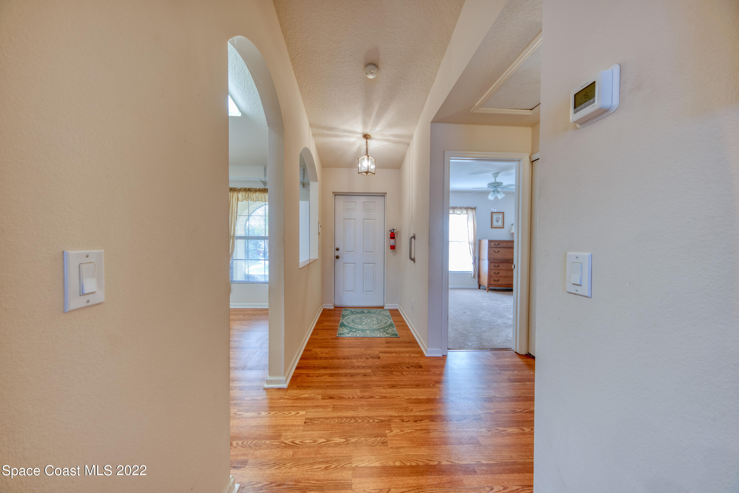 995 Luminary Circle, Unit 103 Melbourne, FL 32901 - Photo 21 of 27 a view of a hallway with wooden floor