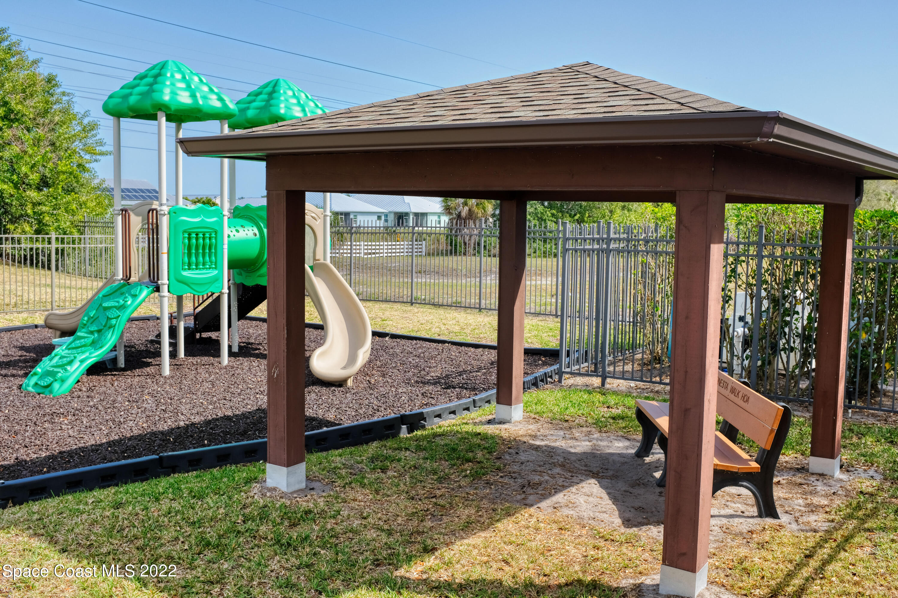 995 Luminary Circle, Unit 103 Melbourne, FL 32901 - Photo 22 of 27 a backyard of a house with barbeque oven table and chairs