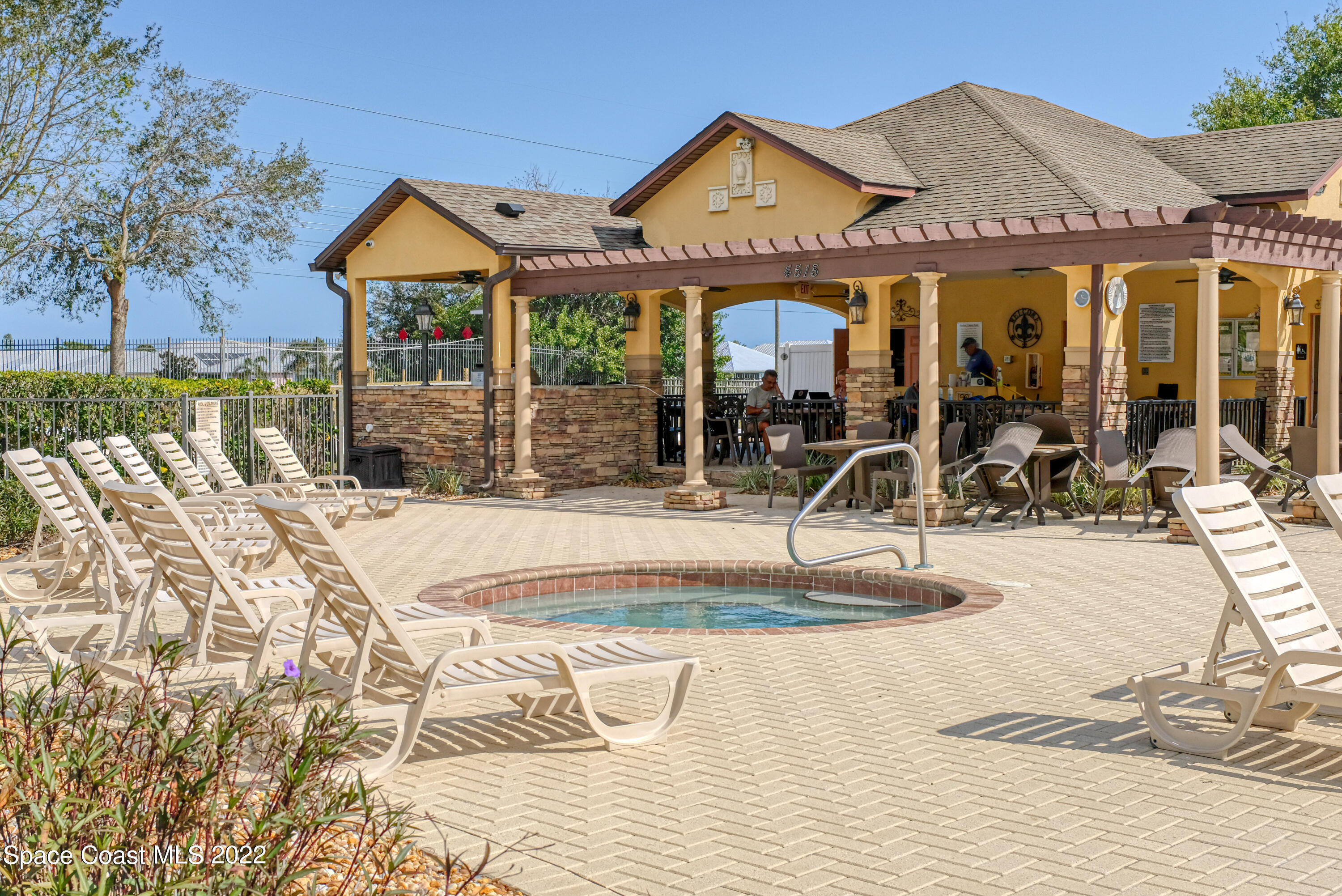 995 Luminary Circle, Unit 103 Melbourne, FL 32901 - Photo 23 of 27 a view of a house with wooden floor and a yard